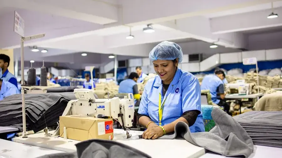 Textile factory workers operating sewing machines
