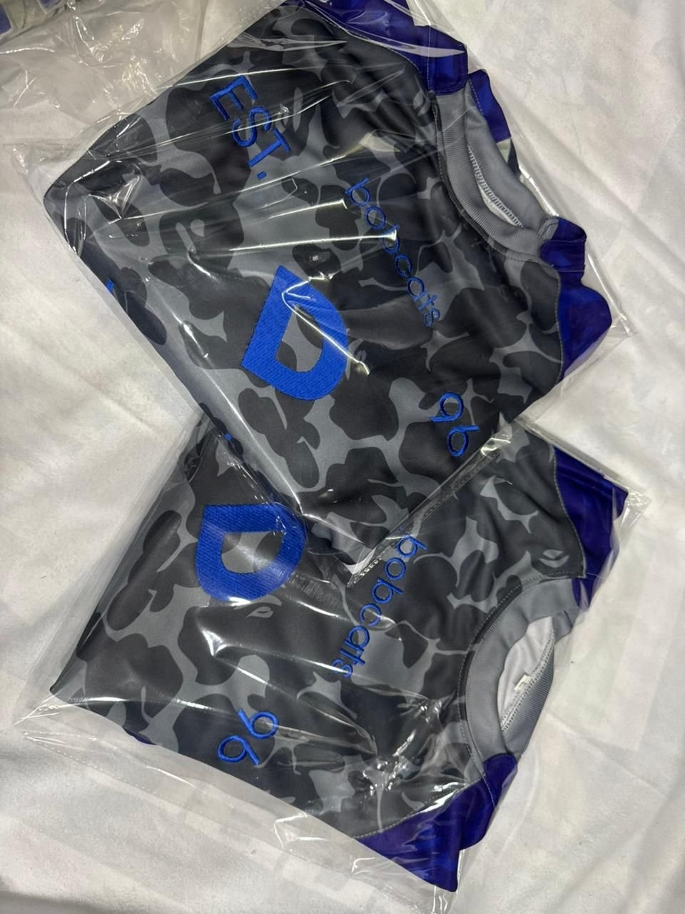 Camo jerseys folded and bagged, in-memory tribute patch detail