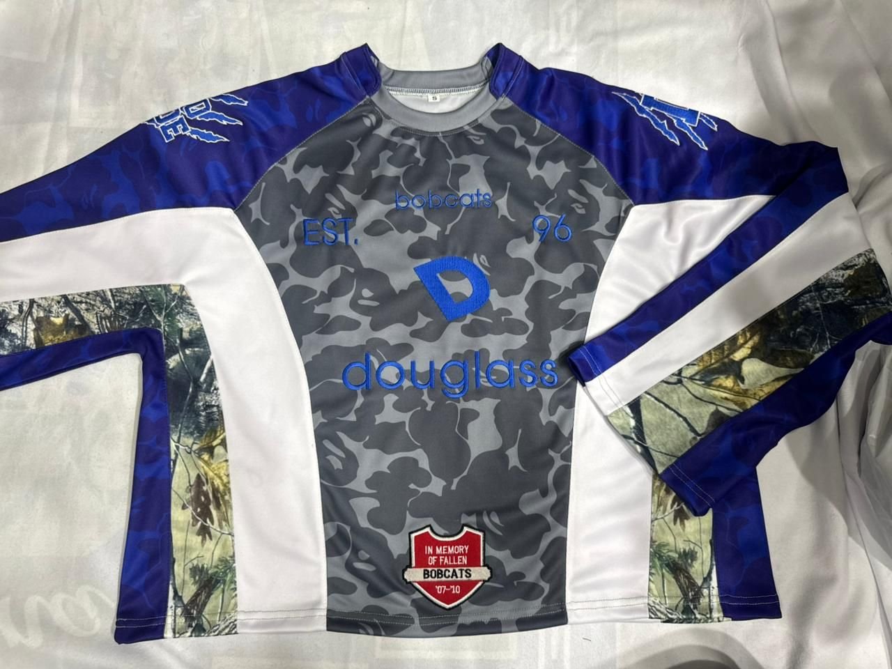 Custom camo long-sleeve crew jersey with embroidered wordmark, front