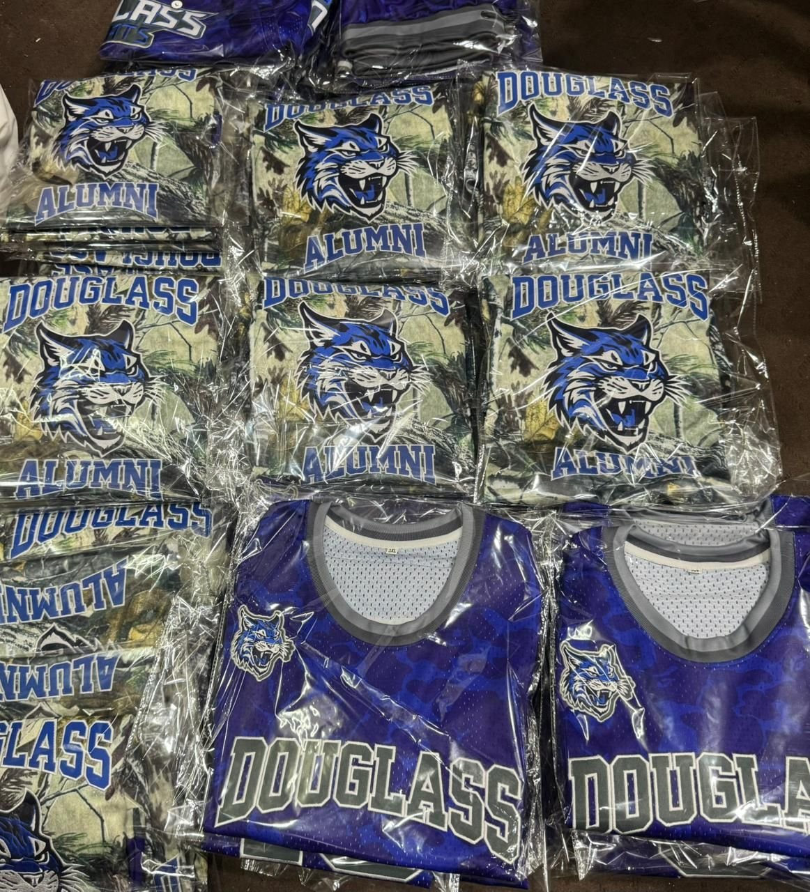 Full bulk order of alumni jerseys packed and organized by size