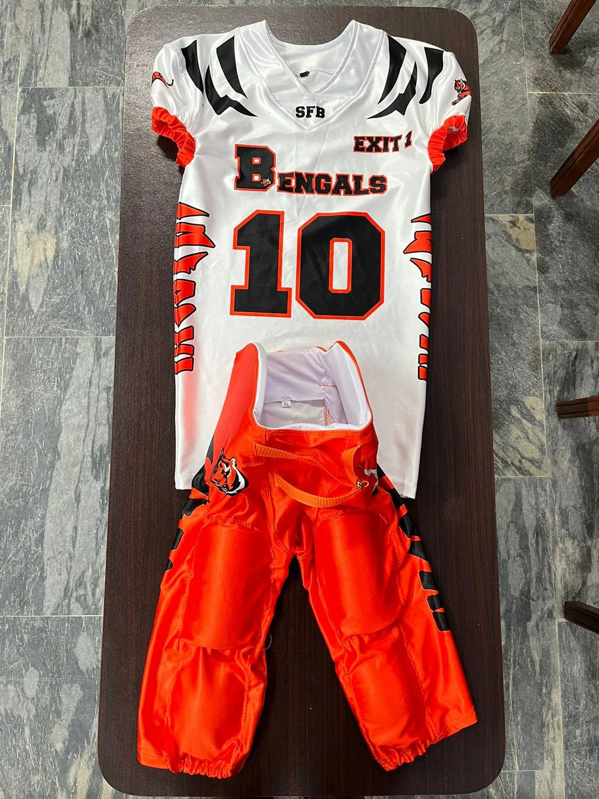 Custom American football jersey and padded game pants, sublimated team branding