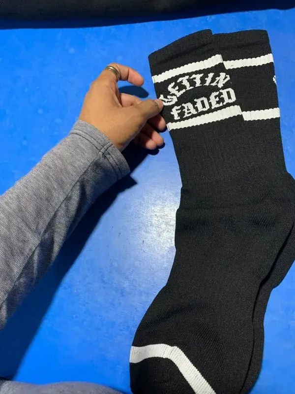 Custom knitted crew socks, black with white "Gettin' Faded" wordmark, private-label pair