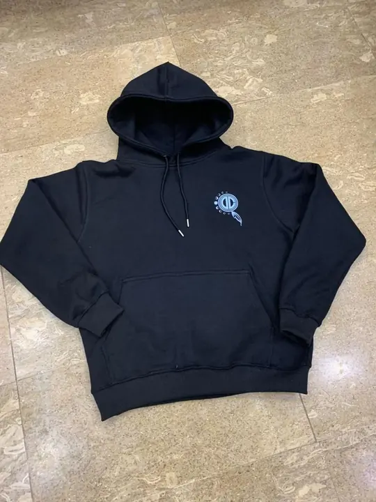 Custom black pullover hoodie with a small embroidered chest logo, flat lay