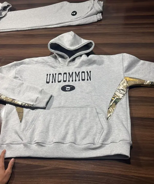 Custom grey hoodie with camo and metallic gold panel inserts and a printed chest graphic