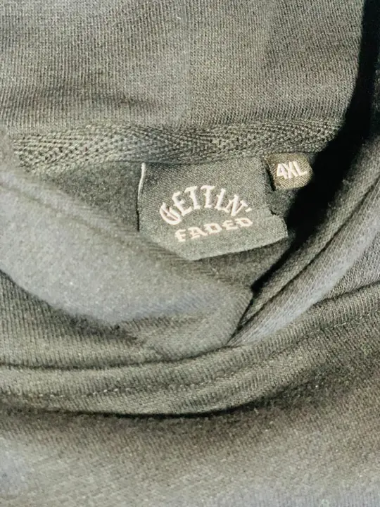 Close-up of a woven neck label stitched inside a custom heavyweight hoodie