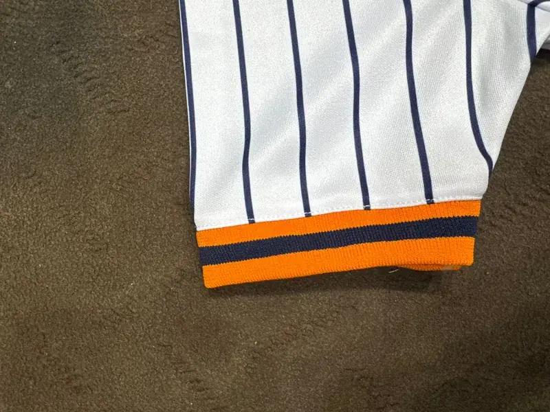 Pinstripe baseball jersey sleeve cuff trim detail