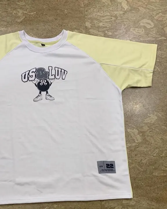Custom white raglan tee with cream sleeves and a printed chest graphic, flat lay