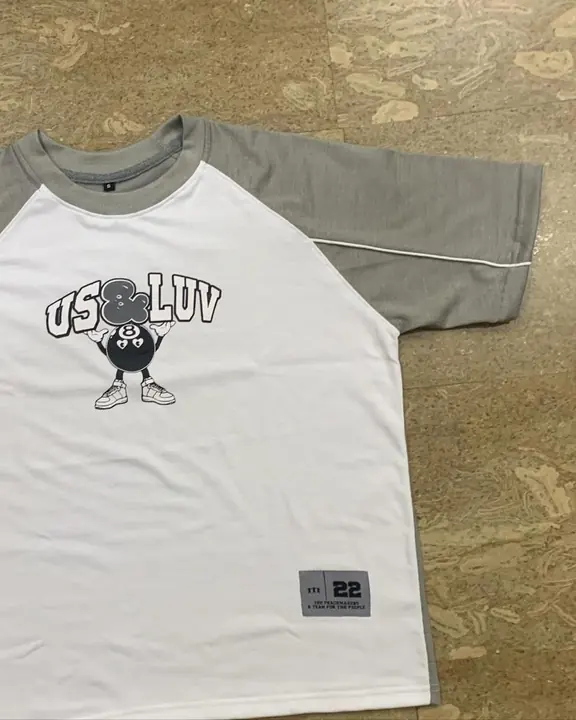 Custom white raglan tee with grey sleeves and a printed chest graphic, flat lay