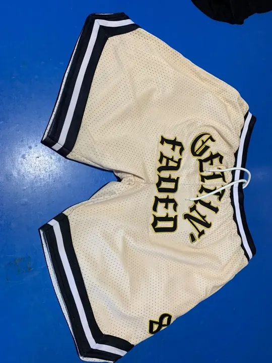 Custom cream mesh basketball-style shorts with embroidered lettering and contrast trim