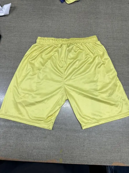 Custom yellow training shorts, laid flat