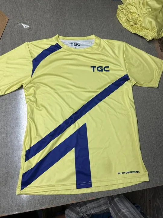 Custom yellow training tee with a navy diagonal stripe and printed chest logo, flat lay