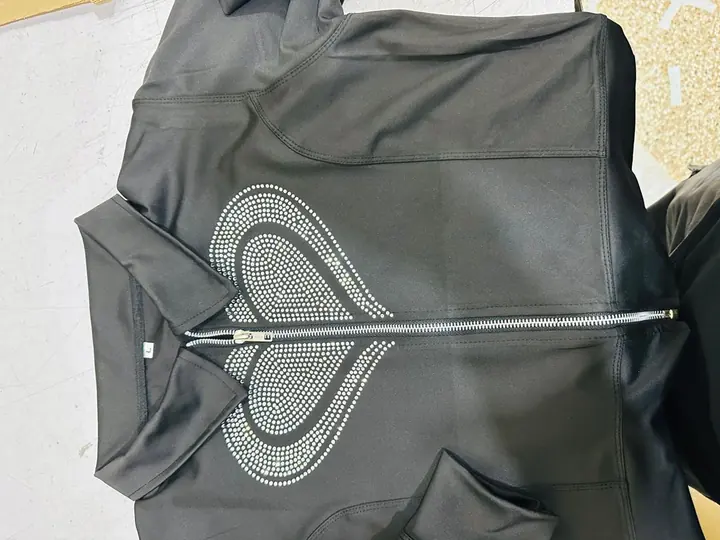 Custom black quarter-zip hoodie with a rhinestone heart-and-spade graphic