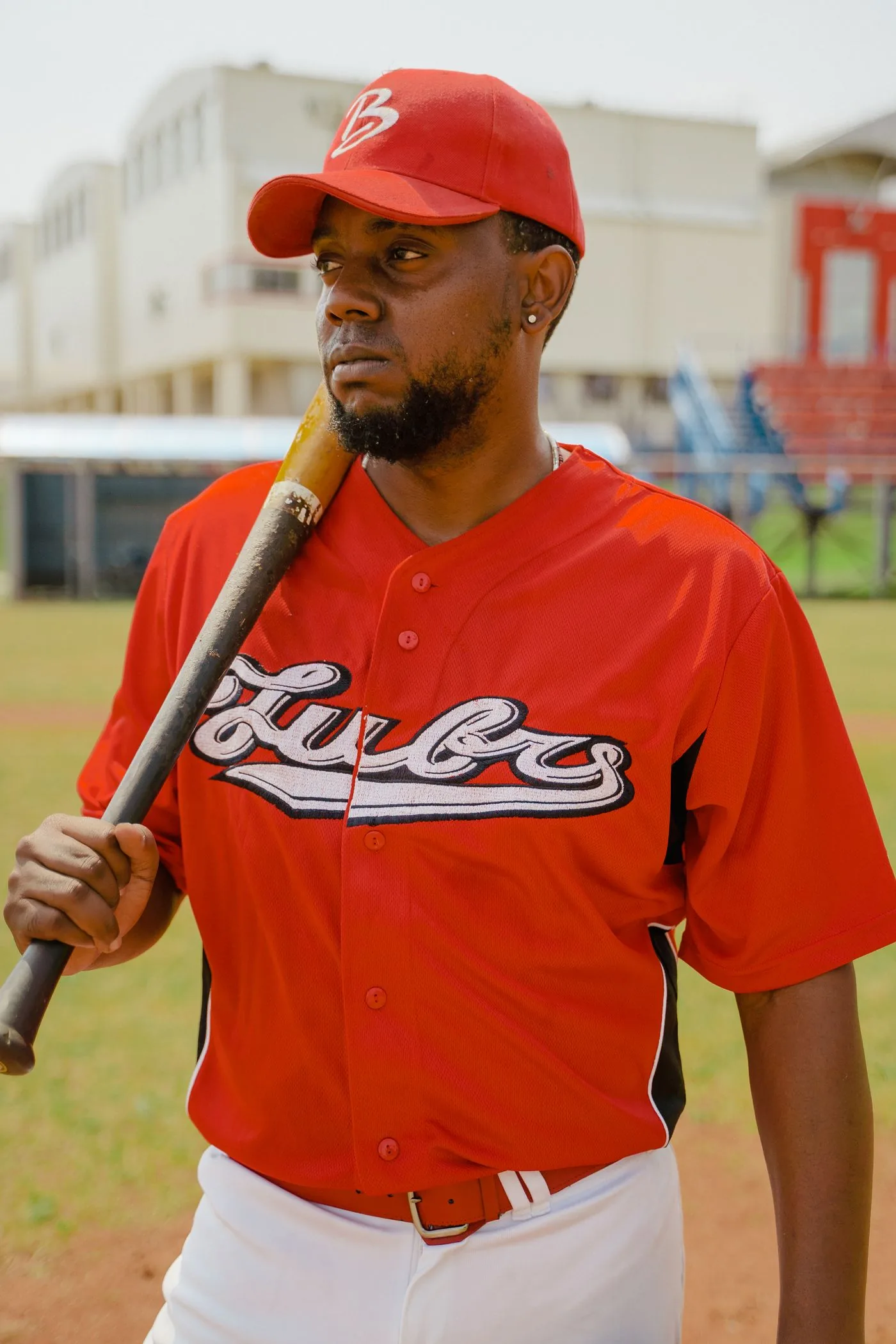 Baseball player in custom team uniform holding a bat