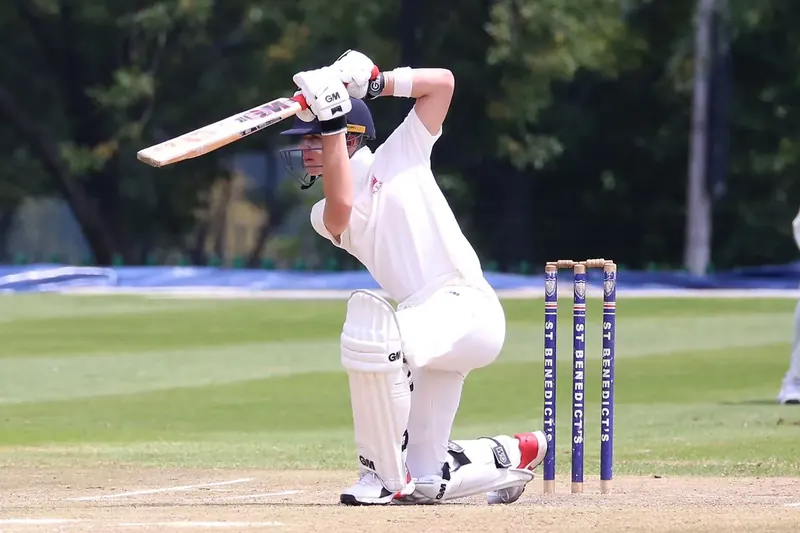 Cricket player in white club uniform