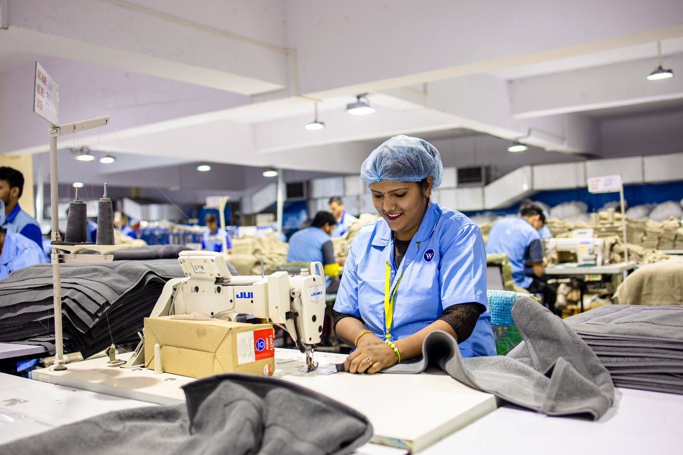 Textile factory workers operating sewing machines